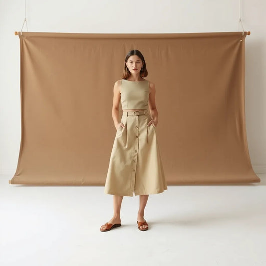 Model wearing a matching cropped top and midi skirt set in a minimal studio setting